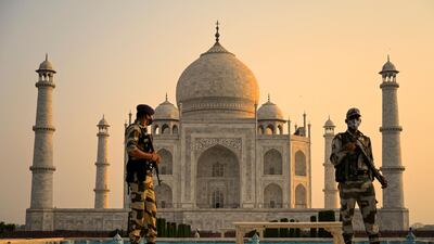 Soldiers patrol the ground at the Taj Mahal after it reopened to visitors following authorities easing Covid-19 coronavirus restrictions in Agra. AFP