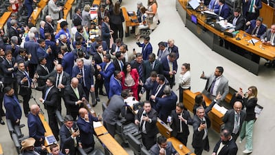 Brazilian politicians celebrate after voting to reduce former president Jair Bolsonaro's prison sentence for plotting a coup. AFP
