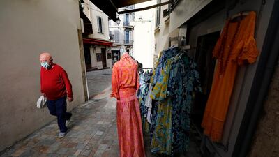 A man walks past a clothing store during the lockdown in Cannes. EPA