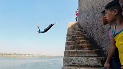 An Egyptian teen jumps into the water of the Nile on the outskirts of Cairo. EPA