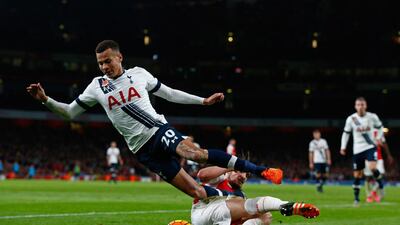 Dele Alli of Spurs is tackled by Mathieu Debuchy of Arsenal. Clive Rose / Getty Images