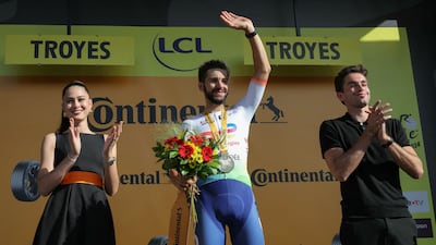 TotalEnergies team's French rider Anthony Turgis celebrates on the podium after winning Stage 9. AFP