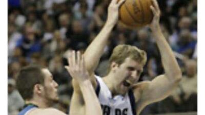 The Dallas Mavericks forward Dirk Nowitzki, right, tries to drive past the Minnesota Timberwolves forward Kevin Love during Tuesday's game, which saw Dallas stage a sensational recovery to win.