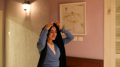 Young Saudi ballet instructor, Rana, adjusts a head scarf during a ballet training session at the Jeddah Ballet Academy, in Jeddah. AMEL PAIN / EPA