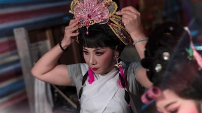 A Chiu Chow opera performer gets ready for the show backstage. EPA