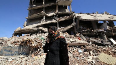 A woman walks past ruined houses in Cizre, Turkey on March 2, 2016. Turkish authorities on Wednesday scaled down a 24-hour curfew imposed on the mainly Kurdish town of Cizre in southeast Turkey, nearly three weeks after declaring the successful conclusion of military operations there. Mahmut Bozarslan/AP Photo