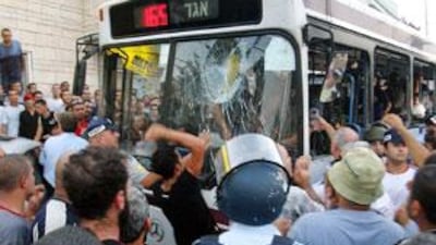 Angry people attack a bus after a shooting in the Israeli Arab village of Shefa'amr in 2005.