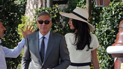 George and Amal Clooney, wearing a Stella McCartney two-piece, leave the Hotel Cipriani in Venice on September 29, 2014, the day of their civil ceremony. EPA