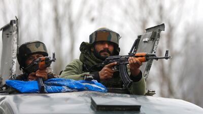 Indian army soldiers patrol on their vehicle near the site gunfight at Pinglena village in Pulwama south of Kashmir. EPA
