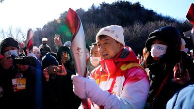 Hong Kong celebrity Jackie Chan holds the 2022 Winter Olympic torch after taking part in the torch relay at the Badaling Great Wall on the outskirts of Beijing, China, Thursday, Feb. 3, 2022. (AP Photo / Ng Han Guan)
