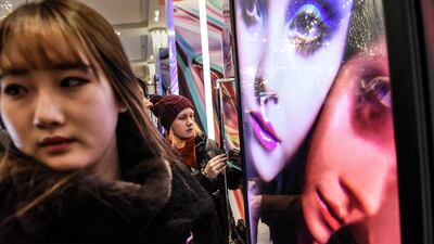 People shop for cosmetics at Macy's. Reuters