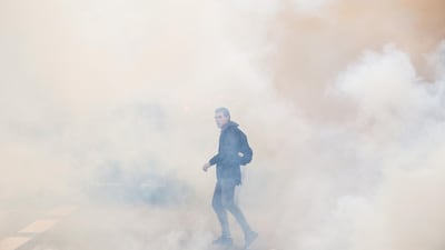A lone protester emerges from clouds of smoke. Jeff J Mitchell/Getty Images