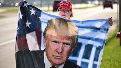 A supporter of former US president Donald Trump waits by Milwaukee Mitchell International Airport in Wisconsin on Sunday. AFP