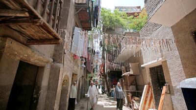 People walk between old buildings in Al Assal. Amr Abdallah Dalsh/Reuters