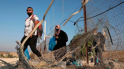 Palestinians enter illegally from a breach in a barrier fence into Israeli territory from the village of Al Dahriya, south the occupied West Bank town of Hebron. AFP