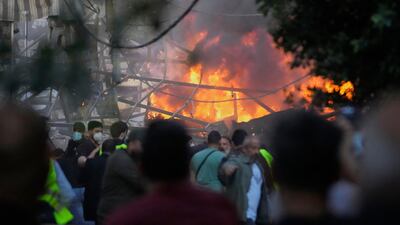 A tent burns in Dahieh after an Israeli air strike. AP