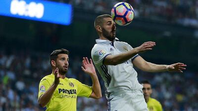 Karim Benzema of Real Madrid wins a header against Villarreal. Gonzalo Arroyo Moreno / Getty Images