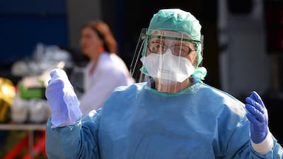 A nurse anesthetist gestures during the disinfection of ambulances, in Brest, western France. AFP