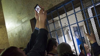 Others scuffled with morgue security men who were blocking their access. Morgue officials later placed a computer outside showing pictures of the dead men for relatives to identify. Hamada El Rasam / AFP Photo