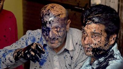 Engineer Rashid, left, a legislator from Jammu and Kashmir state, was doused with ink and engine oil in New Delhi on October 19, 2015, in an attack claimed by the Hindu Sena. Kamal Singh / Press Trust of India via AP