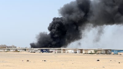 SHARJAH , UNITED ARAB EMIRATES - JUNE 26 : Major fire broke out in the warehouse area in Sharjah Industrial area close to the National Paints in Sharjah. Civil Defense personals trying to control the fire. ( Pawan Singh / The National ) For News. Story by Nawal Al Ramahi