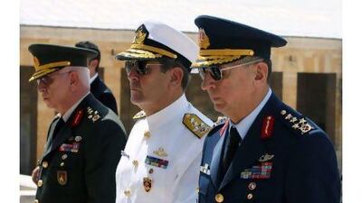 The Turkish chief of staff, General Isik Kosaner, left, the navy commander, Admiral Esref Ugur Yigit, centre, and the air force commander, General Hasan Aksay. General Kosaner and the commanders of the navy, the army and the air force suddenly resigned last Friday. Burhan Ozbilici / AP Photo