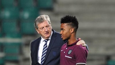 Roy Hodgson, left, seems to be building the England team around Raheem Sterling. Glyn Kirk / AFP