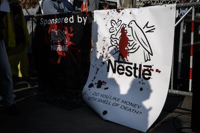Banners against Nestlé at a demonstration against Russia's invasion of Ukraine in Bern. The Swiss food giant has also been accused of supporting Israel in its war against Gaza. AFP