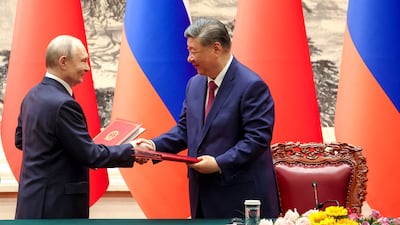 Mr Putin and Mr Xi shake hands during a signing ceremony. AFP