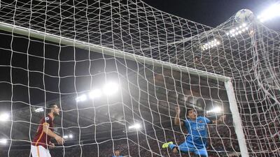 Barcelona's Luis Suarez heads the ball in from an Ivan Rakitic, unseen, cross on Wednesday night for the opening goal in an eventual 1-1 draw with AS Roma in the Champions League. Gregorio Borgia / AP