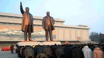 Crowds bow on February 16, 2014, to the statues of North Korea’s late leader Kim Jong Il, right, and his father, North Korea’s founder Kim Il Sung, which tower over the capital Pyongyang on a hill. North Korea marked the anniversary of the birth of Kim Jong Il on Sunday. Jon Chol Jin / AP photo