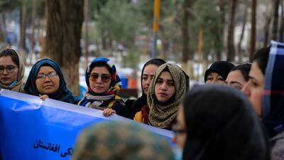 Afghan women and activists hold a banner and demand for food, jobs, and education for girls in Kabul, Afghanistan, January 12, 2022. AFP