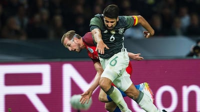 England’s striker Harry Kane (L) and Germany’s defender Sami Khedira vie for the ball during the friendly football match Germany v England at the Olympic Stadium in Berlin on March 26, 2016. / AFP / ODD ANDERSEN