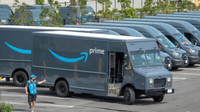 An Amazon worker walks in an Amazon Delivery Station parking lot in Miami, Florida. EPA