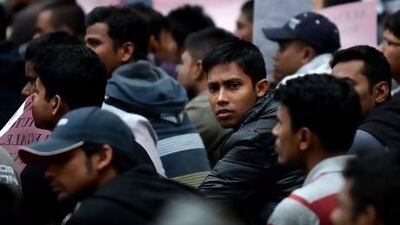 Young Bangladeshi immigrants demonstrate in front of the Italian parliament in Rome to protest against laws that require them to leave the country after they turn 18.
