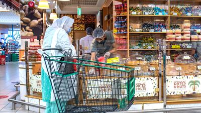 A shopper in Abu Dhabi's Khalidiyah Mall. The non-oil economy of the emirate grew by 5.7 per cent in the first half of the year. Victor Besa / The National