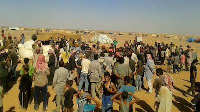 Community leaders distribute meagre food supplies at the Rukban refugee camp. AP