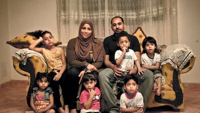 Youssef Shaman Gumaa and his wife Sarah Hassan Shehata with their 4 year-old quintuplets and their 7 year-old sister at their home during the holy month of Ramadan, in Cairo, in a 2017 photograph. AP