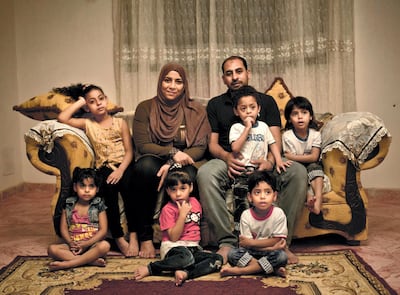 Egyptian father Youssef Shaman Gumaa and his wife Sarah Hassan Shehata pose for a photograph with their 4 year-old quintuplets and their 7 year-old sister at their home in Madinet Al Salam on the outskirts of Cairo. AP, file May 2017