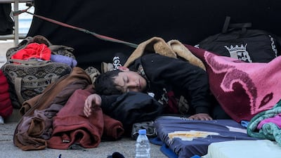 A child sleeps in a makeshift encampment along Beirut's waterfront on Tuesday, one of many civilians who fled the city's southern suburbs due to Israeli bombardment. AFP