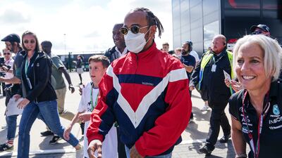 Mercedes driver Lewis Hamilton arrives in the paddock. PA