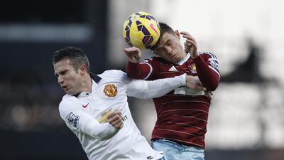 Manchester United’s Robin van Persie and West Ham’s Aaron Cresswell in an aerial duel for the ball at Upton Park, London. Adrian Dennis / AFP
