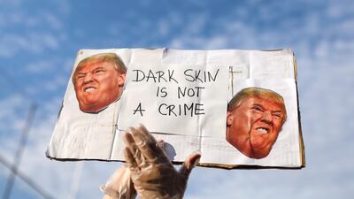A person carries a banner during a protest against the death in Minneapolis police custody of George Floyd, in front of a US consulate, in Barcelona, Spain June 1, 2020. Reuters