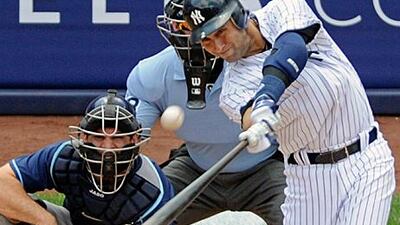 Derek Jeter hits his 3,000th hit for a home run over left field for the New York Yankees against Tampa Bay Rays.