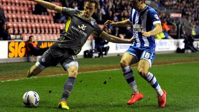 James McArthur, right, of Wigan Athletic in action with Andy King of Leicester City during the Sky Bet Championship match between Wigan Athletic and Leicester City at DW Stadium on Tuesday in Wigan, England. Chris Brunskill / Getty Images / April 1, 2014