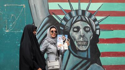 An Iranian woman holds a poster of Iranian Major General in the Islamic Revolutionary Guard Corps (IRGC) Qasem Soleimani during a demonstration near the former US embassy in Tehran, Iran, 4 November, 2018.