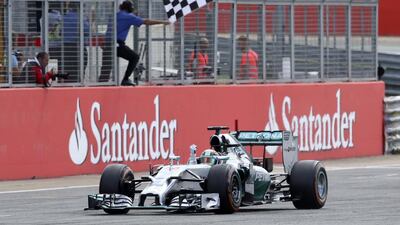 Mercedes Formula One driver Lewis Hamilton crosses the finishing line to win the 2014 British Grand Prix at the Silverstone Race Circuit. Paul Hackett / Reuters