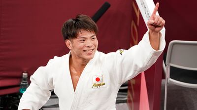 Hifumi Abe, of Japan, celebrates after defeating Vazha Margvelashvili, of Georgia, in the men's -66kg gold medal judo match.