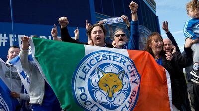 Leicester city football fans celebrate outside the King Power Stadium in Leicester, central England, on May 3, 2016, after the team won the English Premier League title on Monday May 2. Thousands celebrated and millions around the world watched in wonder as 5,000-1 underdogs Leicester City completed arguably the greatest fairytale in sporting history by becoming English Premier League champions. Second-placed Tottenham Hotspur's 2-2 draw at Chelsea late on Monday was enough for last year's relegation battlers Leicester to seal a scarcely credible title after outshining some of football's most glamorous teams. AFP / JUSTIN TALLIS