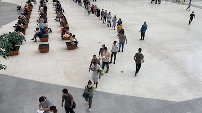 People queue at the Immigration Office in Bangkok, as Thailand moves to close its borders after a spike in the number of coronavirus cases in the past week. AFP